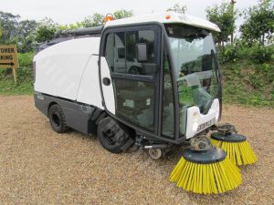 a white road sweeper
